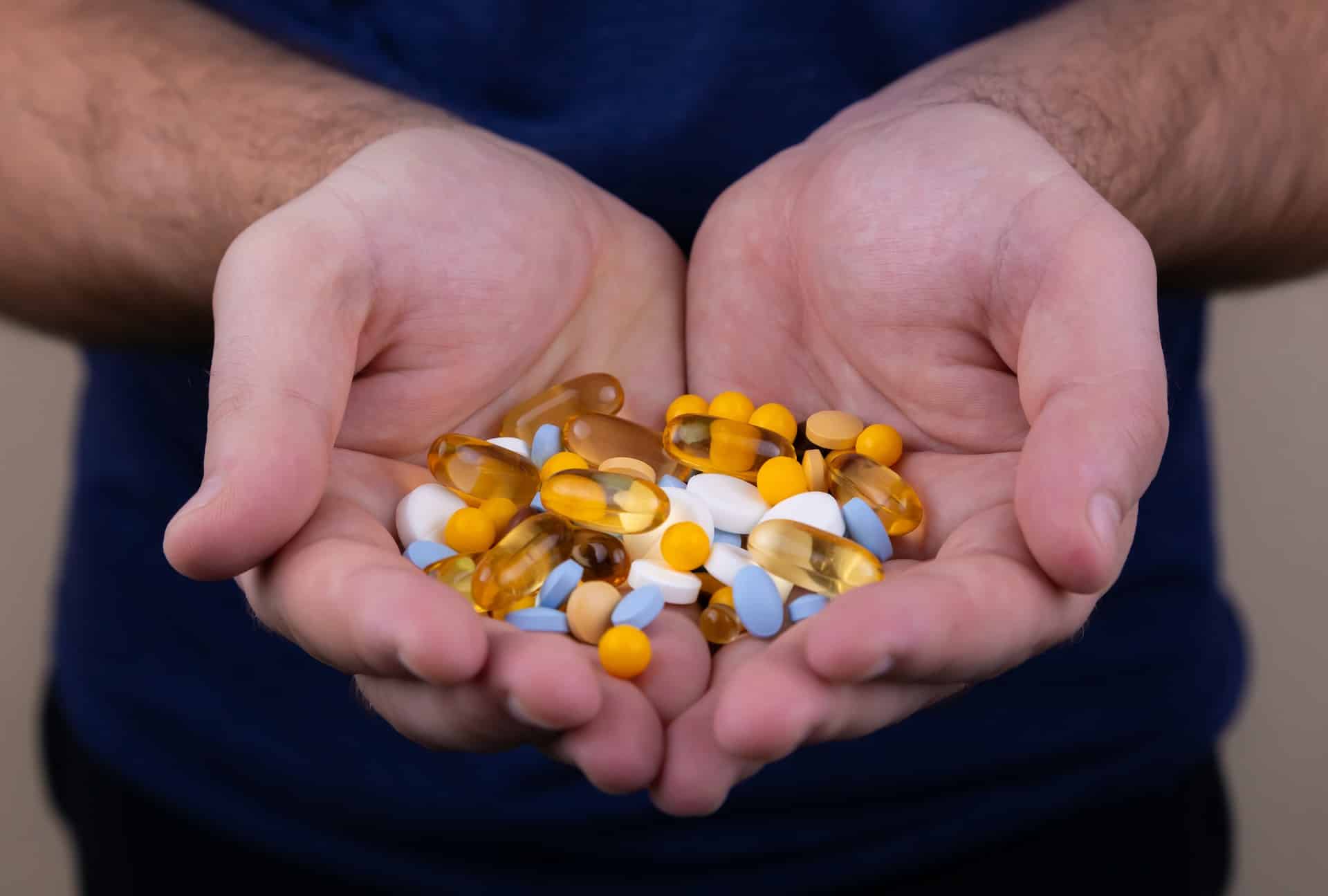 person holding medicine pills person holding medicine pills