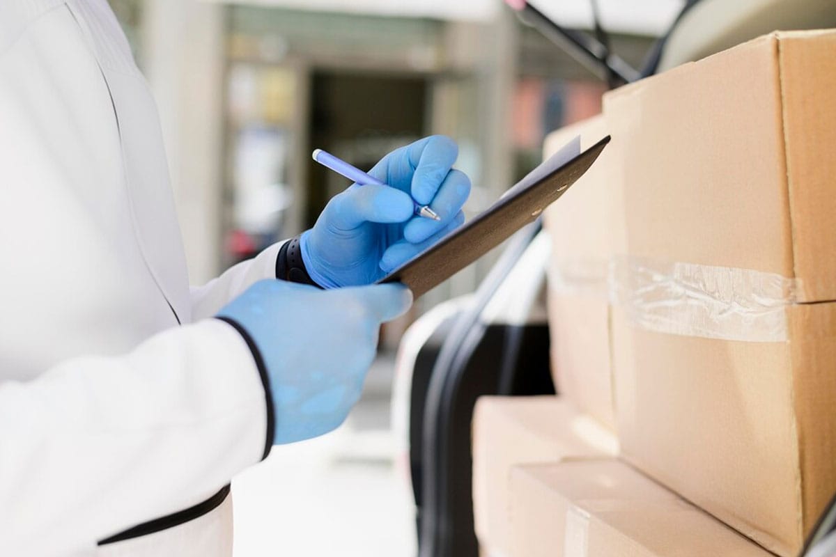 Close-up-individual-checking-delivery-list Close-up individual checking delivery list